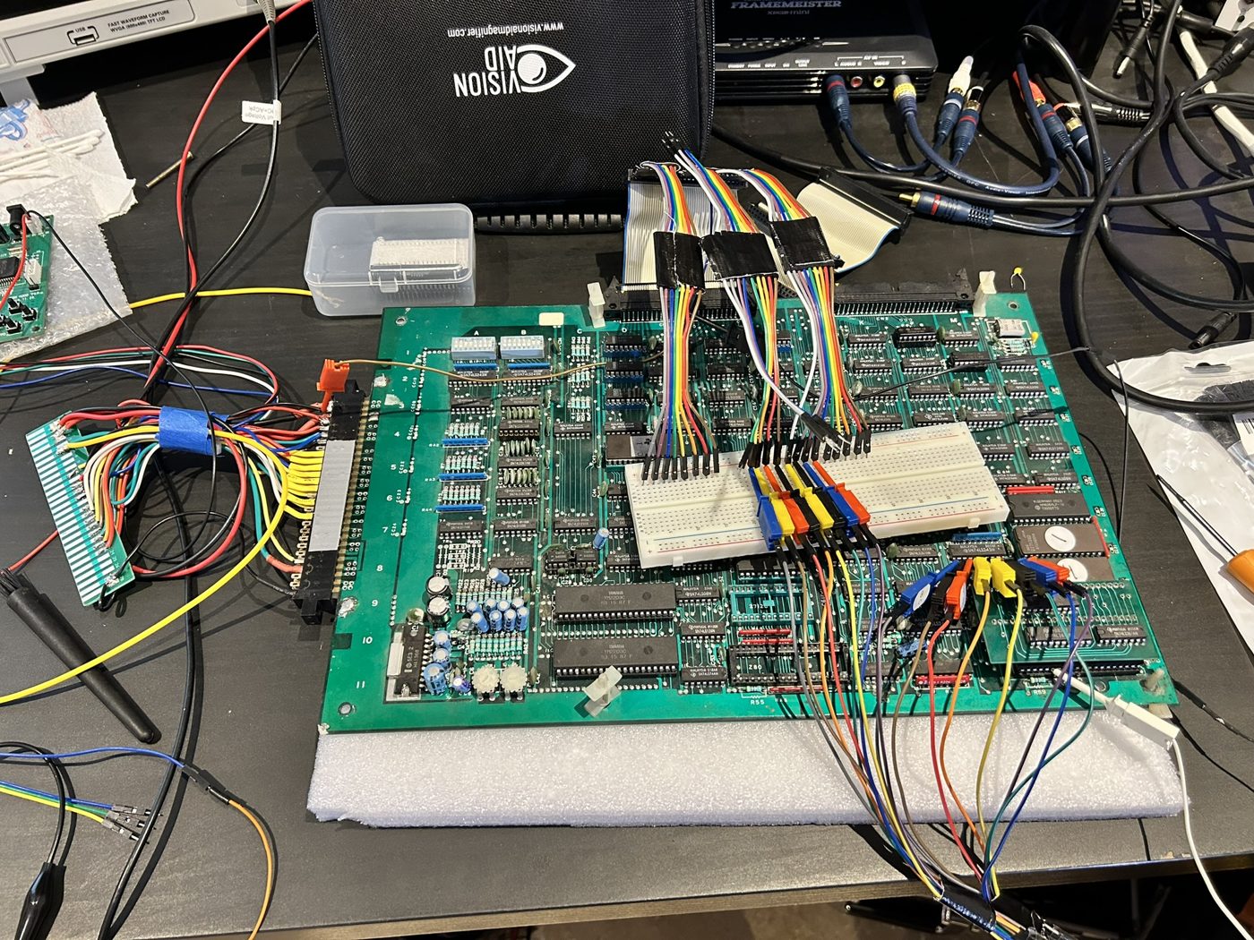 The CPU board on the bench covered in logic analyser clips and jumper wires