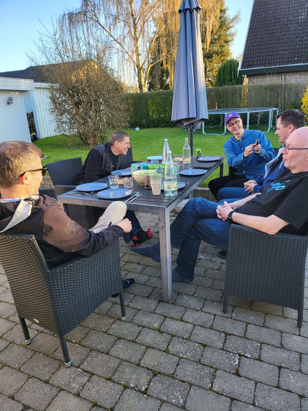 The crew around a table in Trap's garden