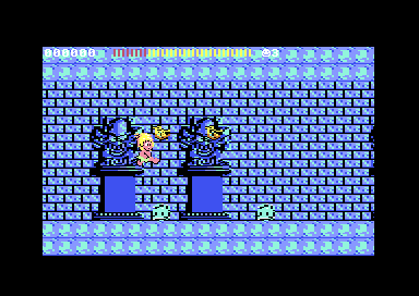 C64 Wonder Boy round 4-3: the boy jumps past dark statues in an icy blue brick castle