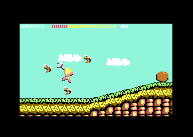 C64 Wonder Boy round 3-2: the boy throws a hatchet mid-jump among four bees on a grassy hillside
