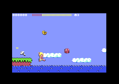 C64 Wonder Boy round 1-2: the boy falls toward the sea past cloud platforms as an octopus leaps